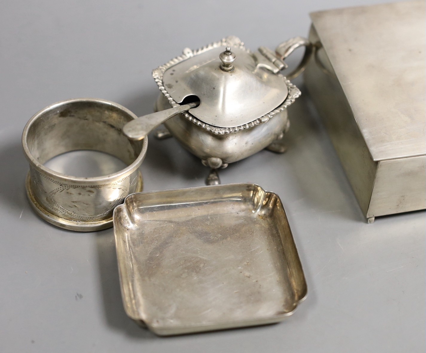 A George V silver mounted cigarette box, 11.5cm and other small sundry silver and plated items including napkin rings, condiments and small dish.